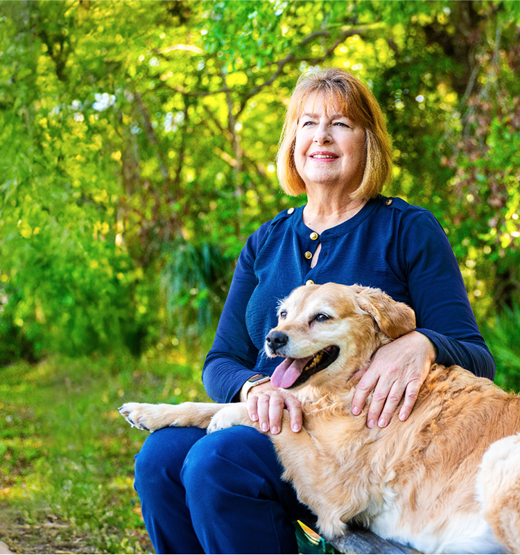 Woman sitting on a bench with her dog